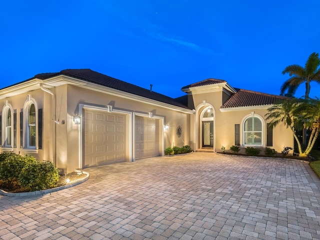 mediterranean / spanish house featuring a garage