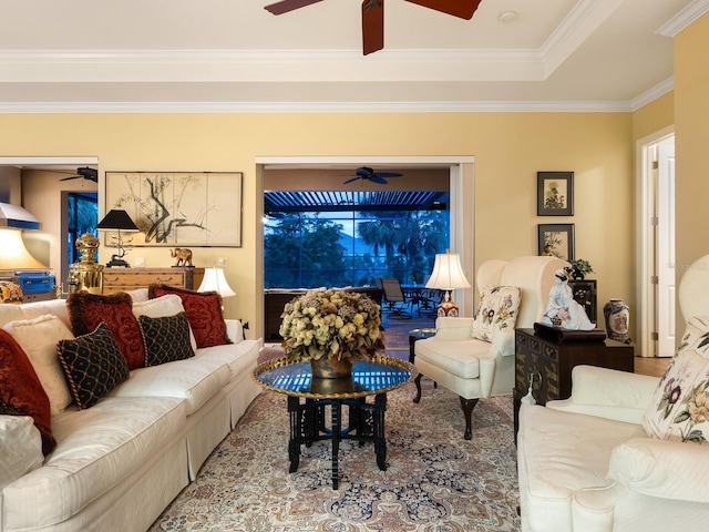 living room with a raised ceiling and ornamental molding