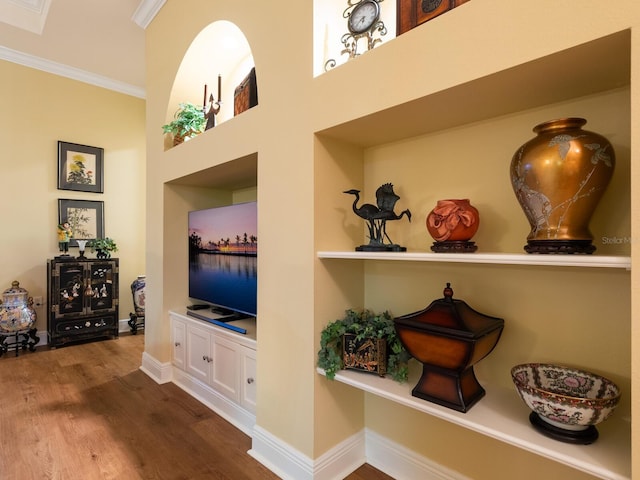 interior space with hardwood / wood-style floors and ornamental molding