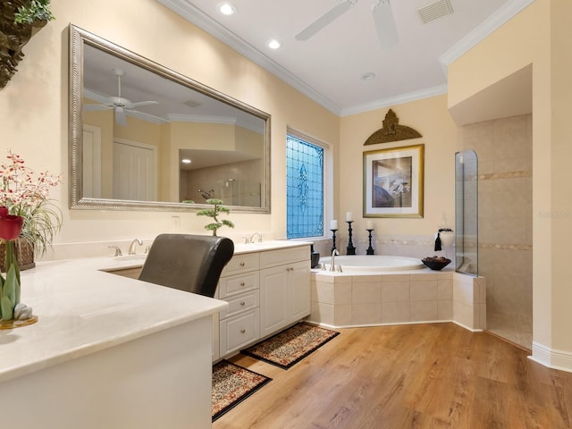 bathroom with vanity, hardwood / wood-style flooring, ceiling fan, ornamental molding, and shower with separate bathtub