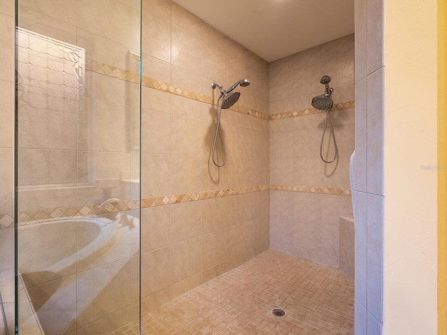 bathroom featuring independent shower and bath