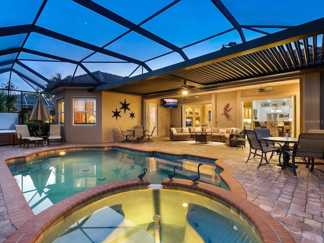 view of pool featuring an outdoor living space, a patio area, an in ground hot tub, and glass enclosure