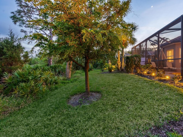 view of yard featuring glass enclosure