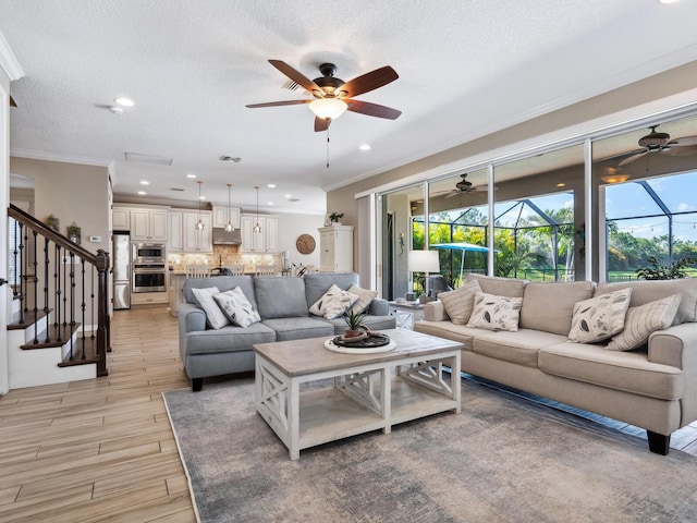 living room featuring ornamental molding and a textured ceiling