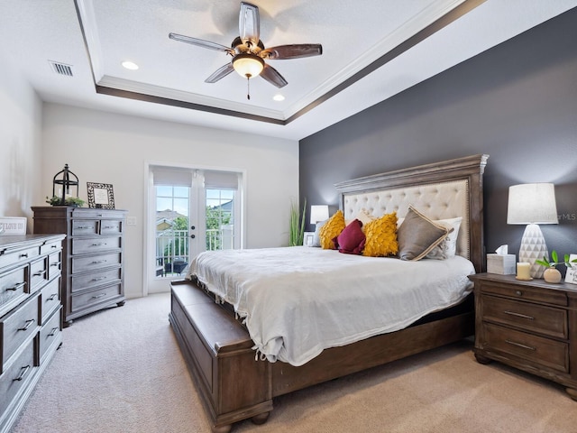 bedroom featuring access to exterior, ceiling fan, crown molding, a tray ceiling, and light carpet