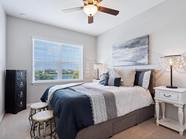 bedroom with light carpet and ceiling fan