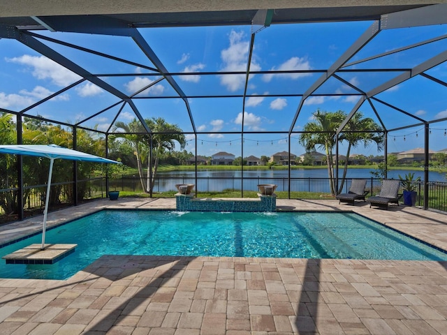 view of swimming pool featuring glass enclosure, pool water feature, a patio area, and a water view