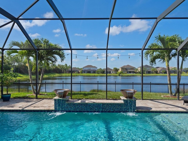 view of pool featuring pool water feature, a water view, and a lanai