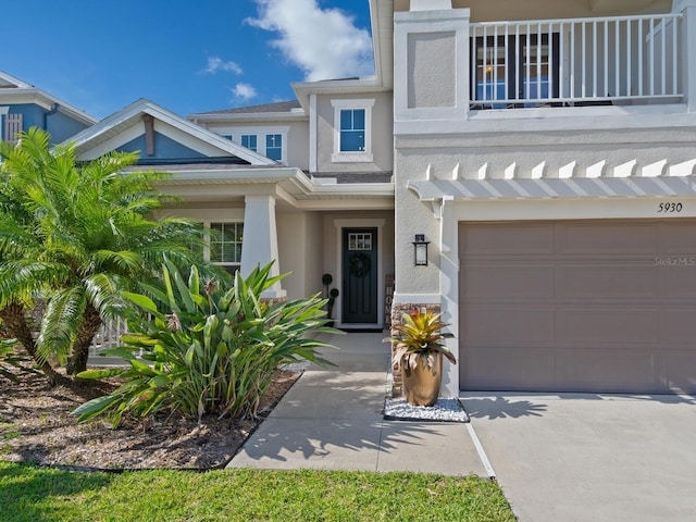 5930 Anise Dr, Sarasota, FL 34238 - view of front of property featuring an attached garage, a balcony, and stucco siding