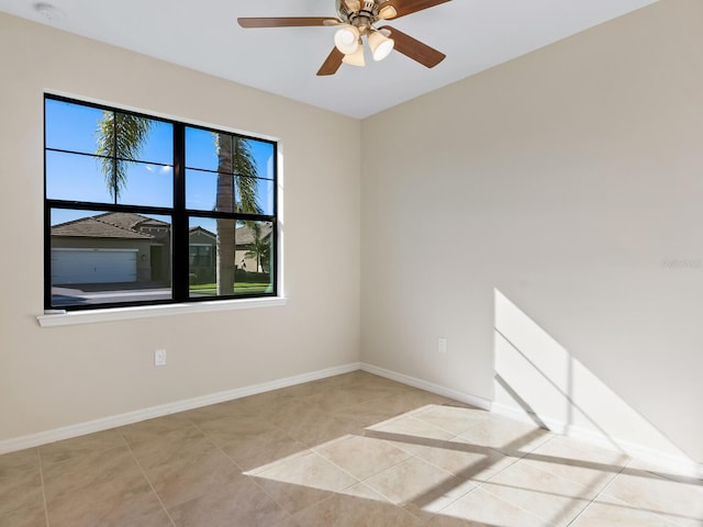 tiled spare room with ceiling fan