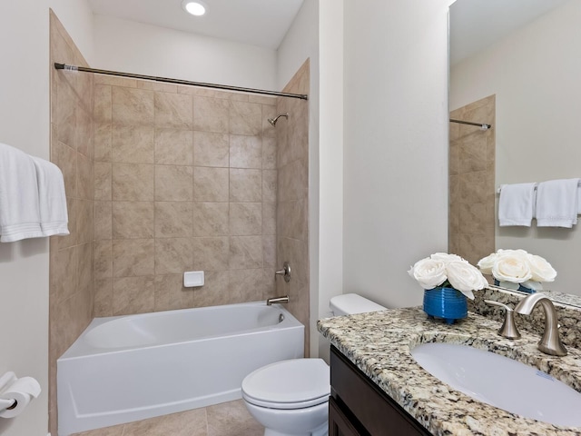 full bathroom with toilet, tiled shower / bath, tile patterned flooring, and vanity