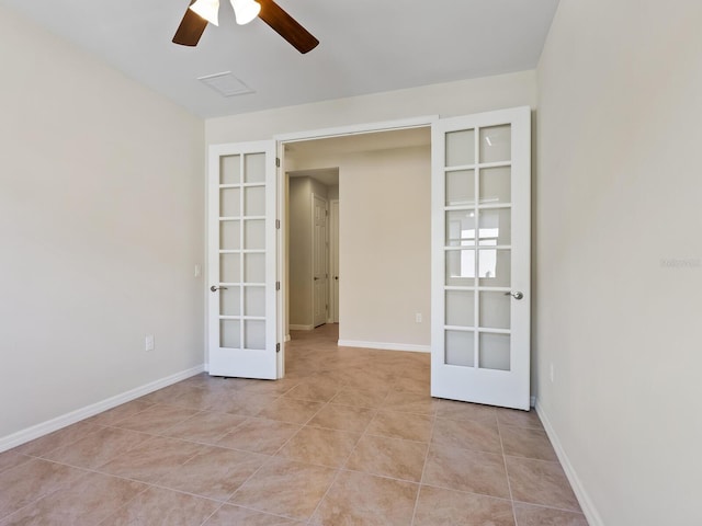 spare room featuring ceiling fan, french doors, and light tile patterned floors