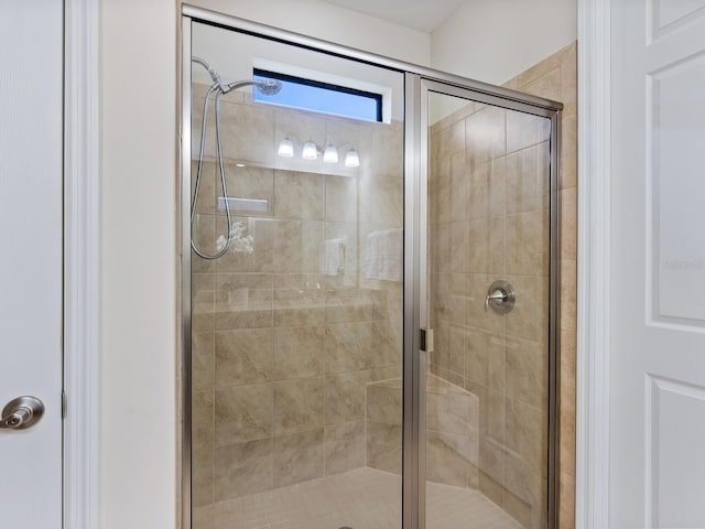 bathroom featuring a shower with door