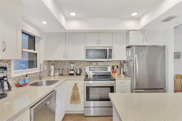 kitchen featuring white cabinetry, sink, and stainless steel appliances