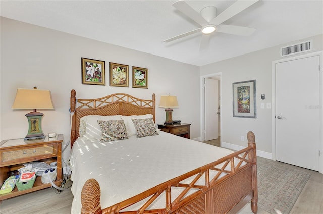 bedroom with ceiling fan and light hardwood / wood-style floors