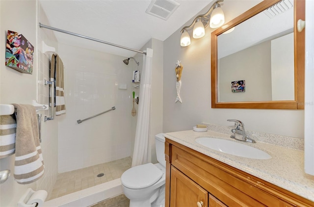 bathroom with a shower with shower curtain, tile patterned floors, vanity, and toilet