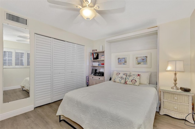 bedroom with ceiling fan, a closet, and light hardwood / wood-style floors