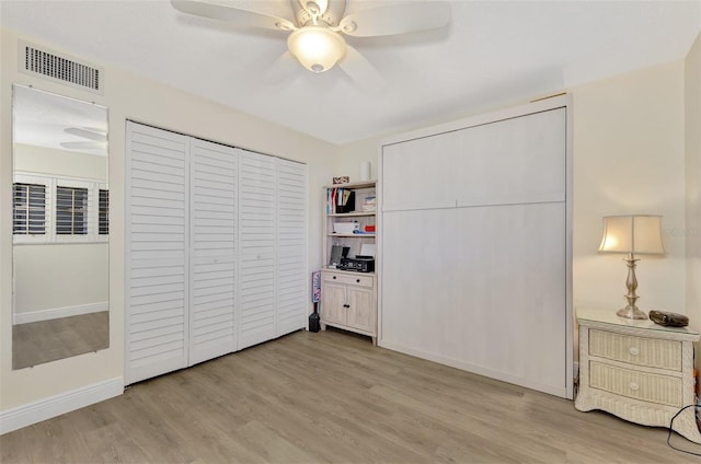 bedroom with ceiling fan, a closet, and light hardwood / wood-style flooring