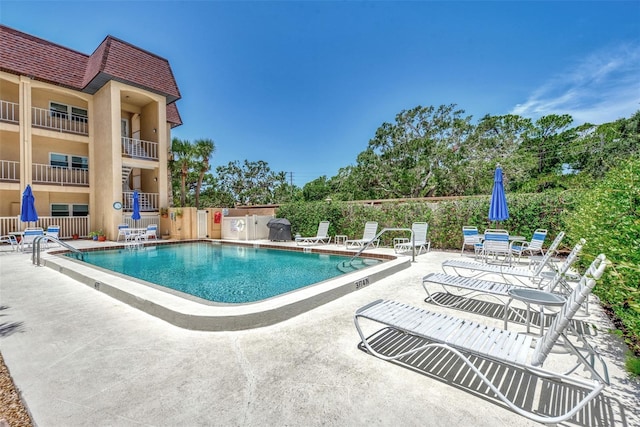 view of swimming pool with a patio area