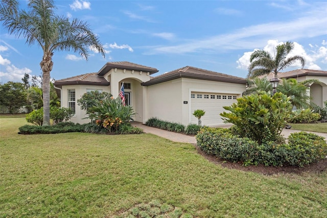 mediterranean / spanish-style home with a garage and a front yard