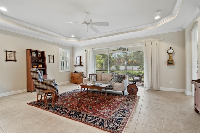 living room with a raised ceiling, crown molding, light tile patterned flooring, and ceiling fan