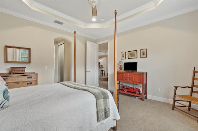 bedroom with a raised ceiling, ceiling fan, ornamental molding, and light tile patterned flooring