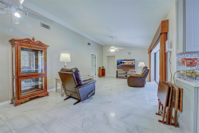 living room featuring a textured ceiling, vaulted ceiling, and ceiling fan