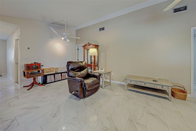 sitting room with ceiling fan and vaulted ceiling