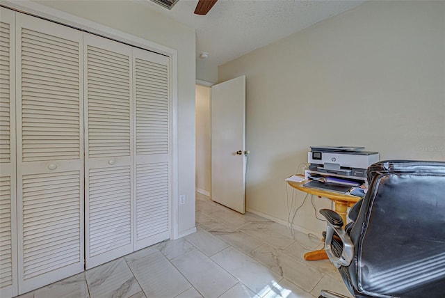 unfurnished office with ceiling fan