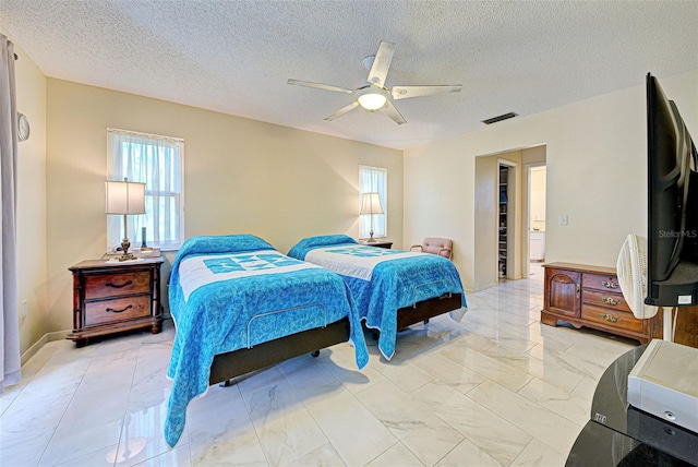 bedroom featuring ceiling fan and a textured ceiling