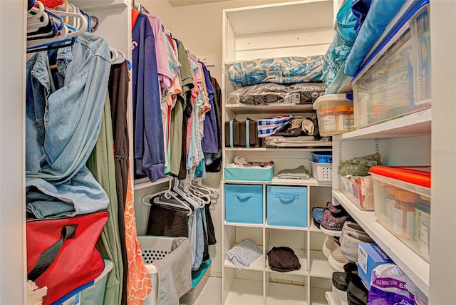 walk in closet with tile patterned floors