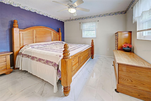 bedroom featuring ceiling fan and a textured ceiling