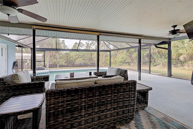 sunroom featuring ceiling fan and a pool