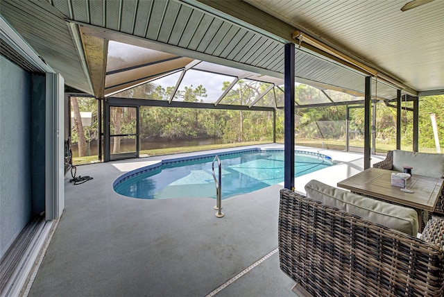 view of pool featuring glass enclosure and a patio