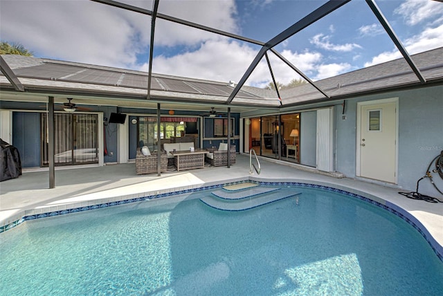 view of swimming pool with an outdoor living space, a lanai, a patio area, and ceiling fan