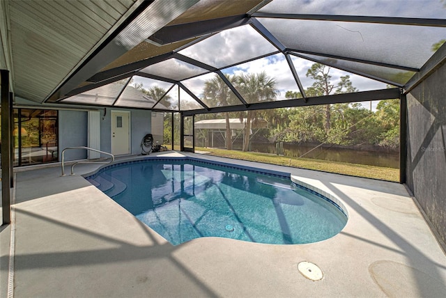 view of pool with glass enclosure and a patio area