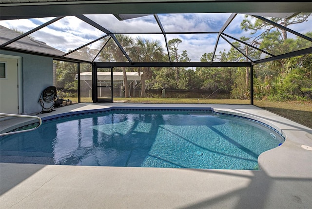 view of swimming pool featuring glass enclosure