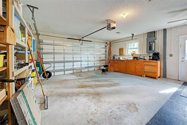 garage featuring a garage door opener and electric panel