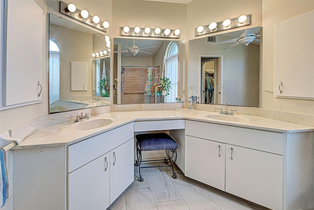 bathroom featuring ceiling fan, curtained shower, and vanity