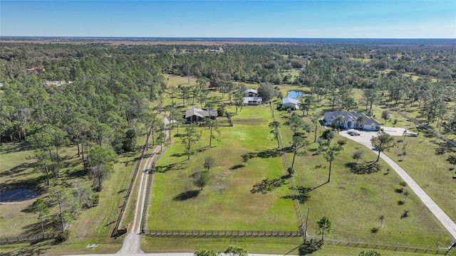 birds eye view of property with a rural view and a wooded view