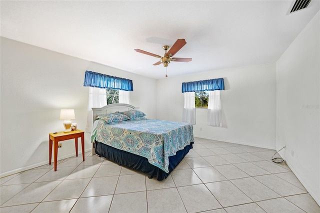 tiled bedroom featuring ceiling fan