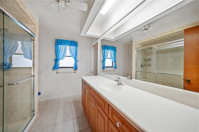 full bath featuring a stall shower, tile patterned flooring, ceiling fan, and vanity