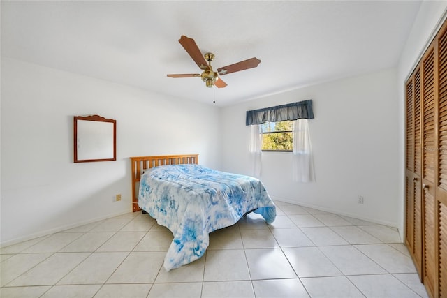 tiled bedroom with a closet and ceiling fan