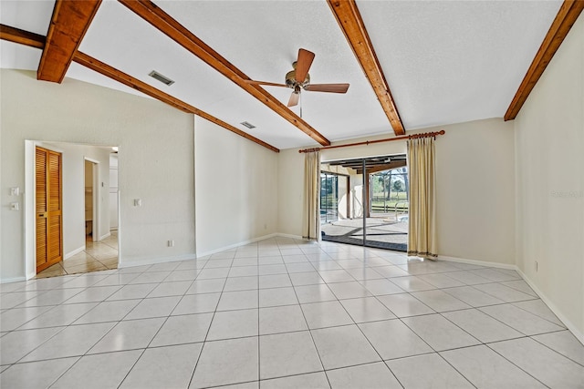 tiled empty room featuring lofted ceiling with beams and ceiling fan