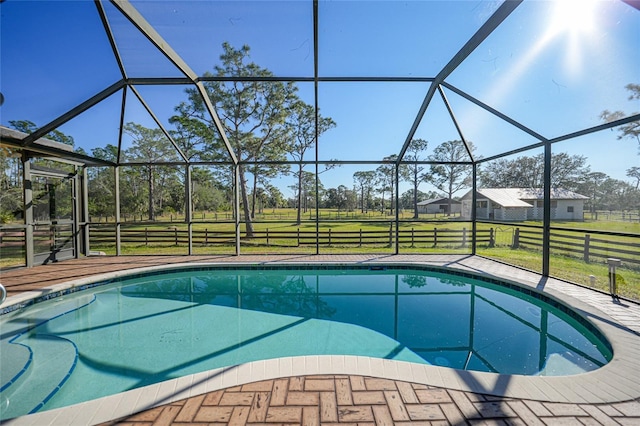 view of swimming pool with a lanai and a yard