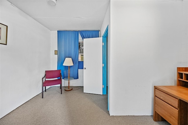 sitting room featuring light colored carpet