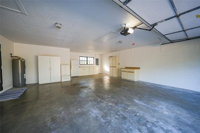 garage featuring water heater, electric panel, freestanding refrigerator, and a garage door opener