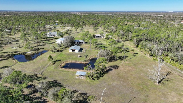 drone / aerial view featuring a wooded view