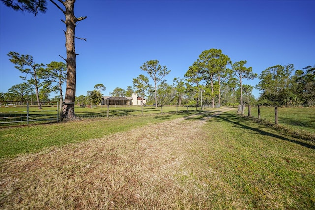 view of yard featuring a rural view and fence