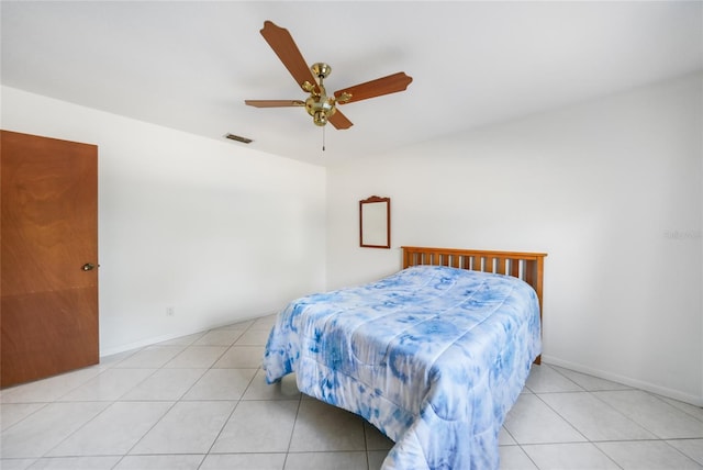 bedroom featuring ceiling fan, light tile patterned flooring, visible vents, and baseboards